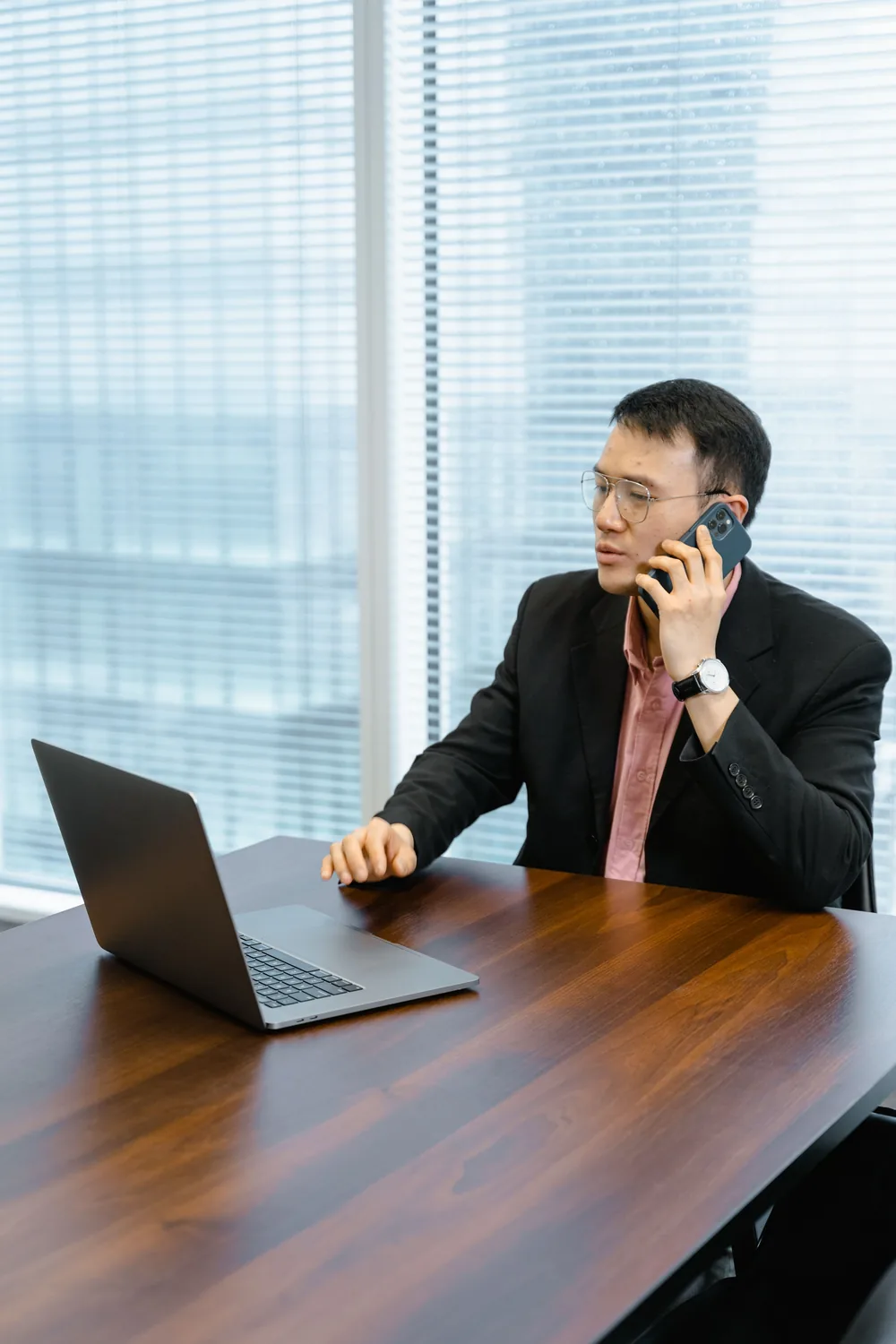 A business owner on a call at his laptop