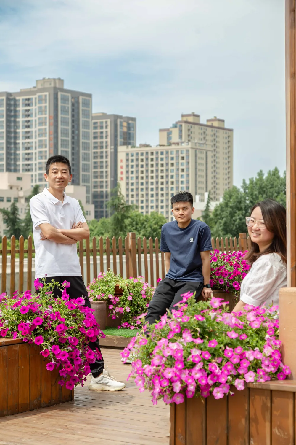 A small team standing on a rooftop terrace